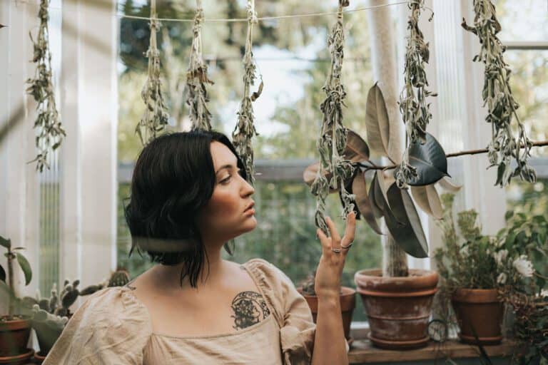 Cassidy among drying herbs in the greenhouse