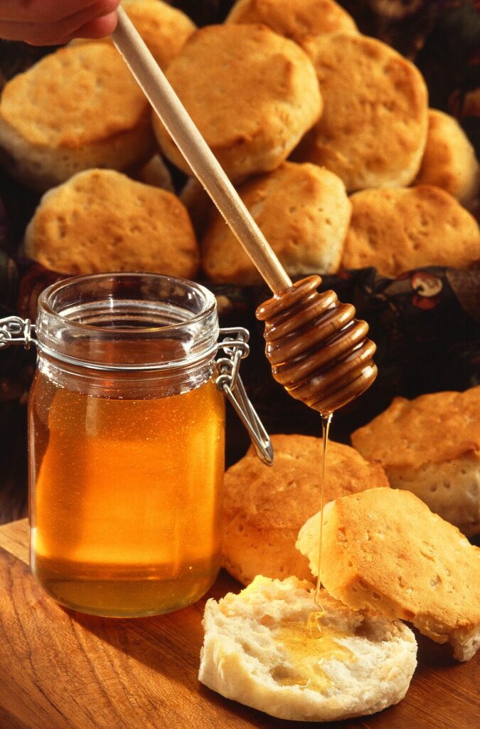 Jar of honey with a wooden honey dipper
